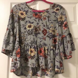 Grey flowy blouse with flower design.
